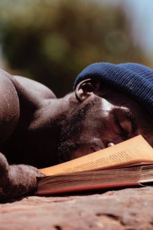 man-lying-beside-a-book-3146082